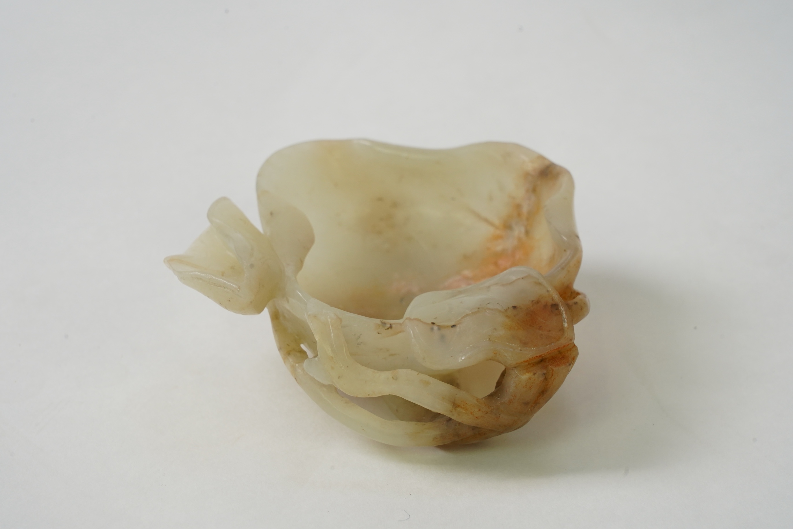 A Chinese pale celadon and russet jade brushwasher, Ming dynasty, 16th/17th century